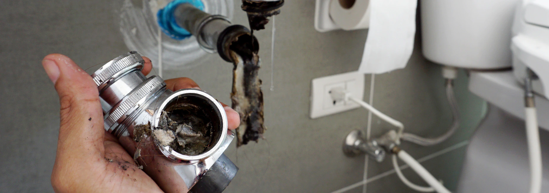 close up plumber hand with a dirty bathroom sink darinage brandon ms